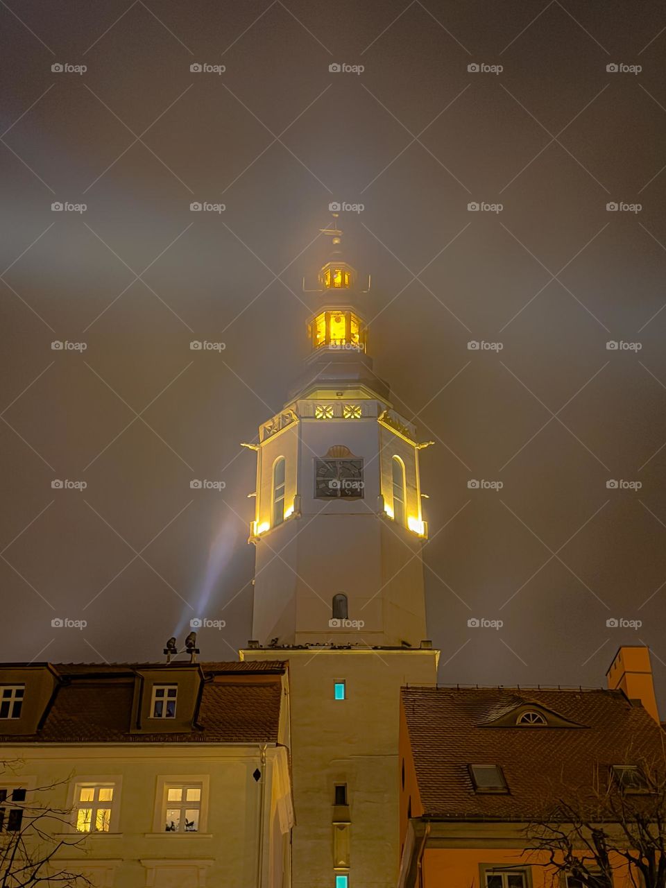 Town hall tower in the warm light in the foggy evening, Poland, Świdnica 