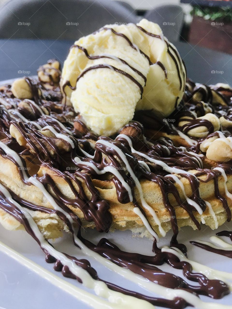Delicious nutty waffles with vanilla ice cream on top 