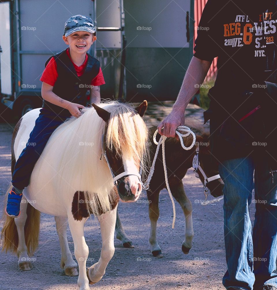 Riding. A boy riding a pony