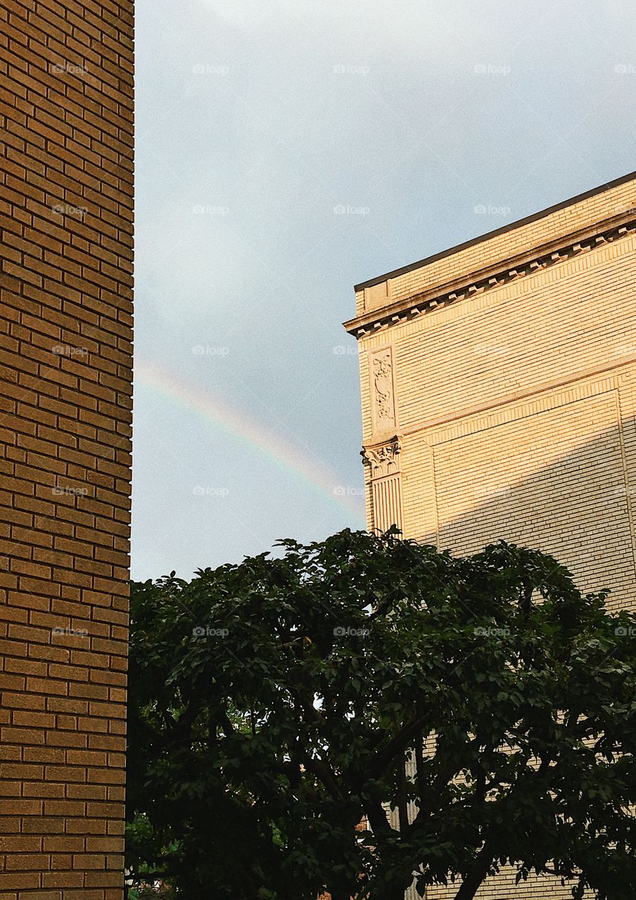 A rainbow through two brick buildings in Boston, Massachusetts 