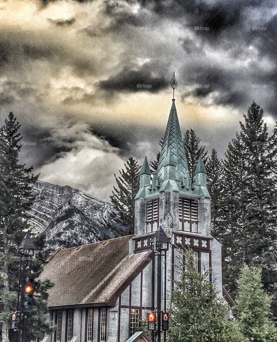 Church building, under a stormy sky, with a glimmer of hope