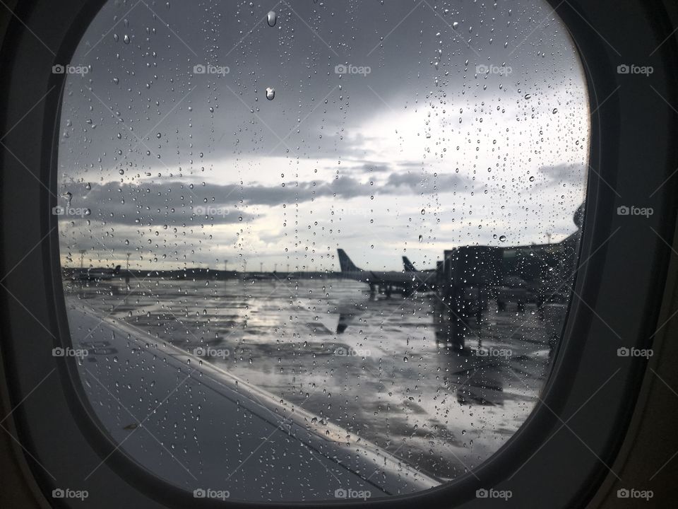 View from the airplane window on a cloudy rainy day.