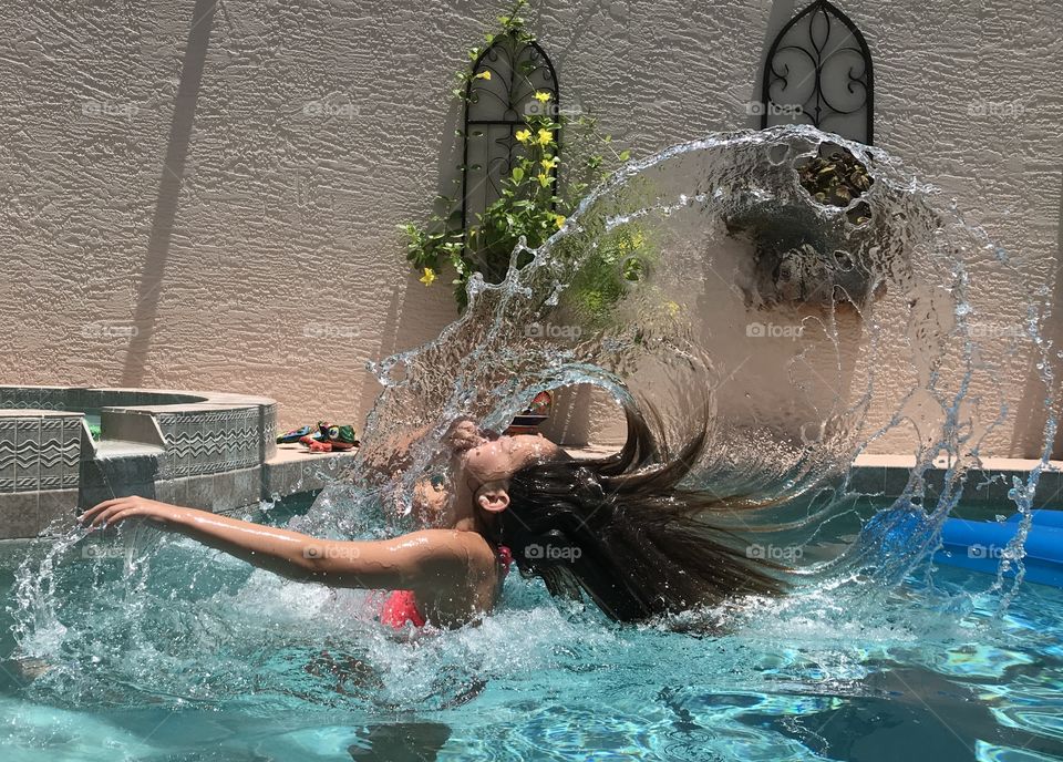 Hair flip in pool making large water wave 