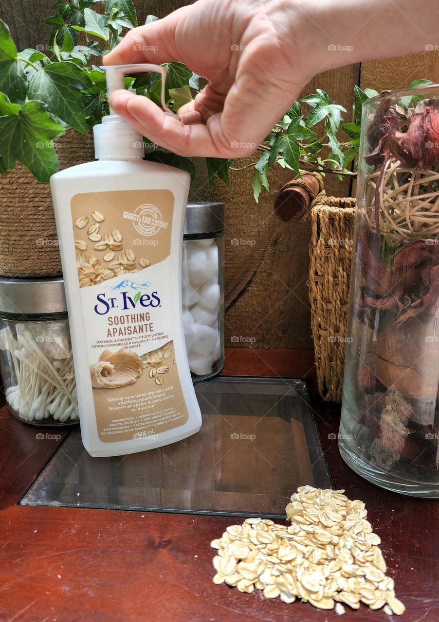 Applying St. Ives soothing oatmeal & Shea butter body lotion