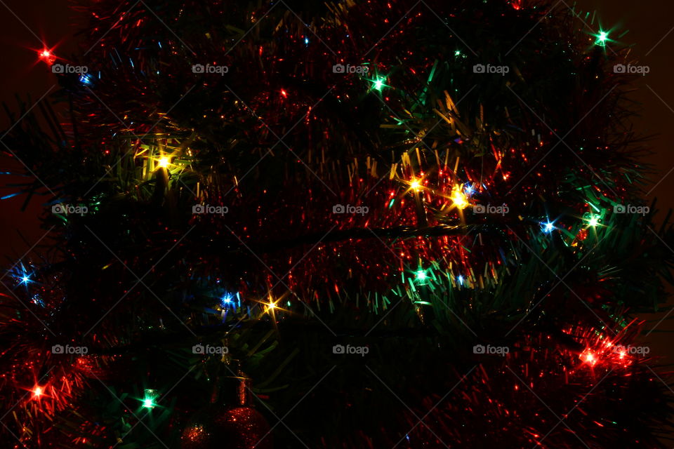 Macro shot of Christmas tree decorations and vivid lights