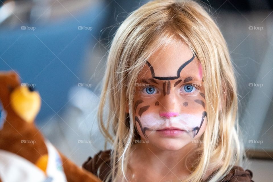 Portrait of a young girl who just got her face painted at a event party