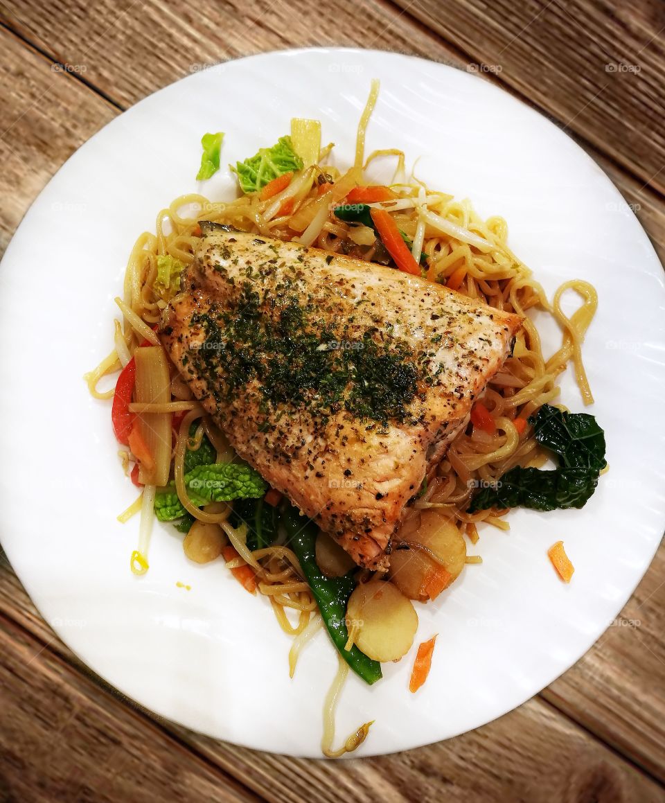 salmon steak on egg noodles