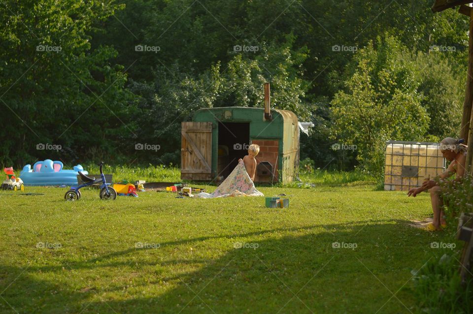 Playing outside in the garden on hot summer evening.