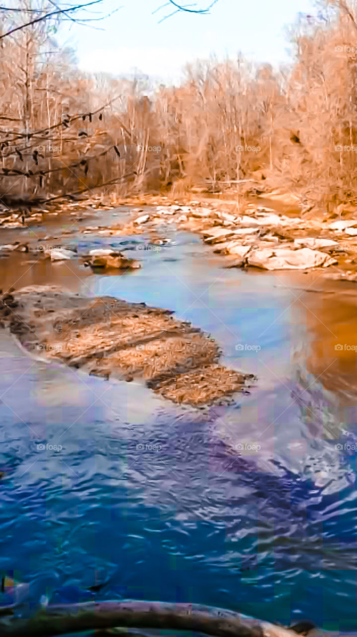 flowing creek with water reflections
