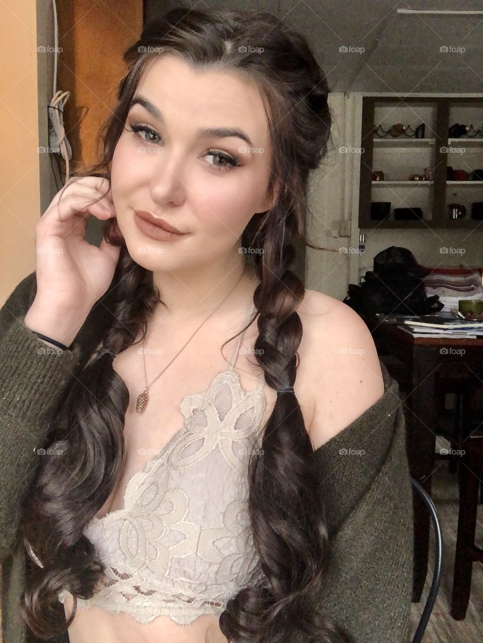 Brunette girl taking a selfie in her kitchen like a typical millennial. 