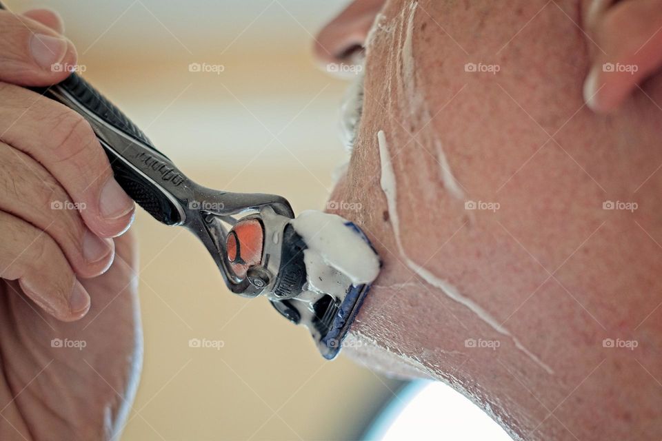 Man shaving his beard