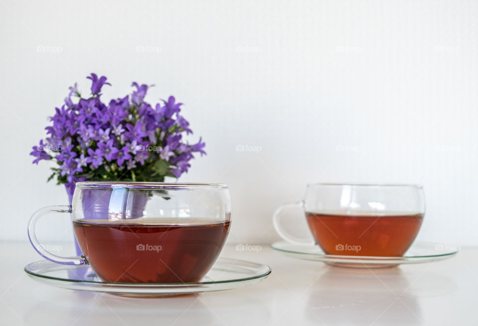 Herbal tea and flowerpot on white background