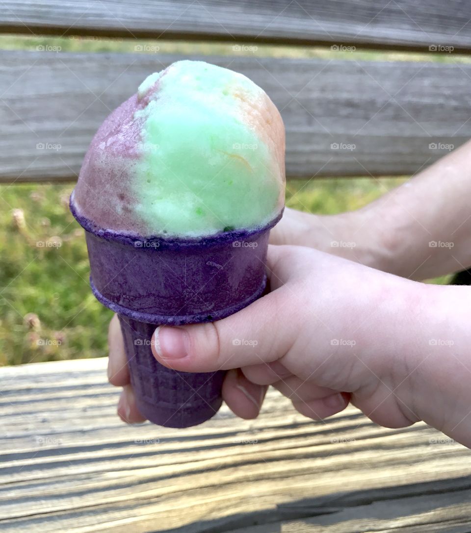 Two hands Holding ice cream cone