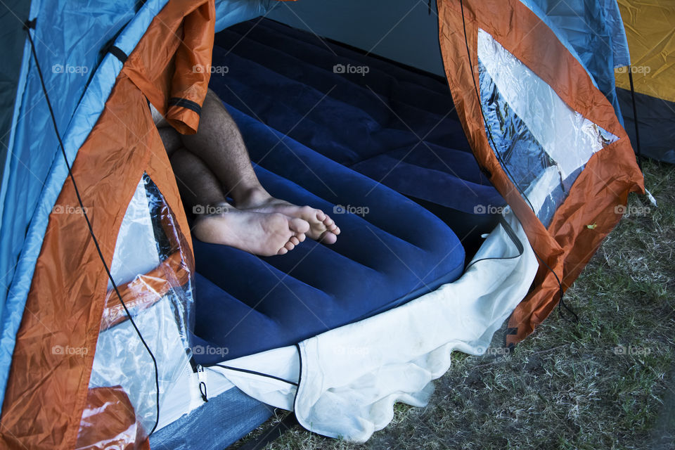 feet in the tent. feet peeking from the tent
