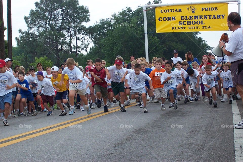 USA school field day in 1999 on a small rural town elementary school children participating on a race