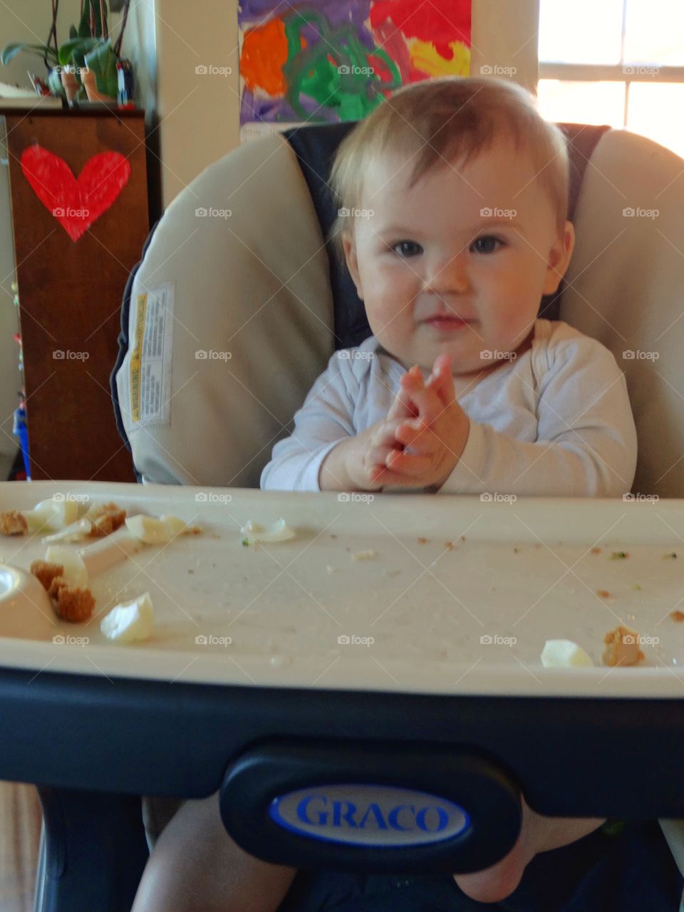 Baby Eating In A Highchair
