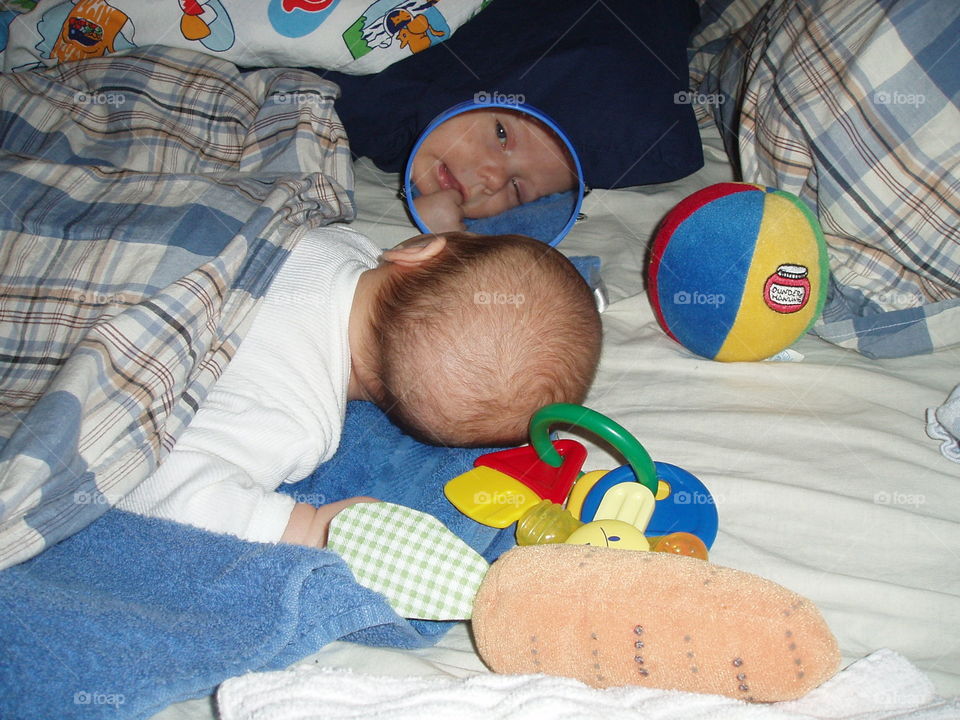 Mirror,mirror on the bed there. Newborn baby sees himself in a mirror!