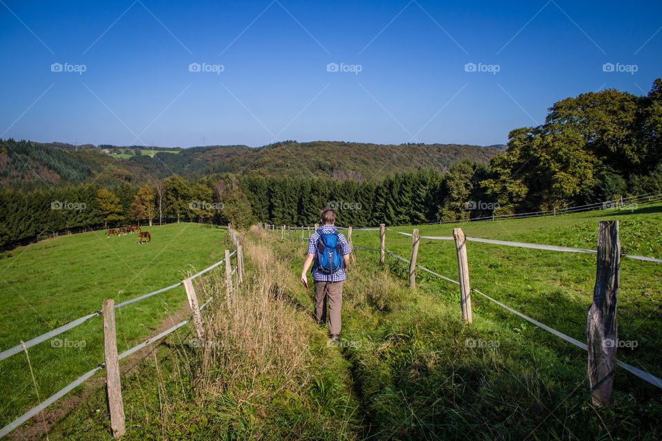 Young male hiking in nature with bagpack