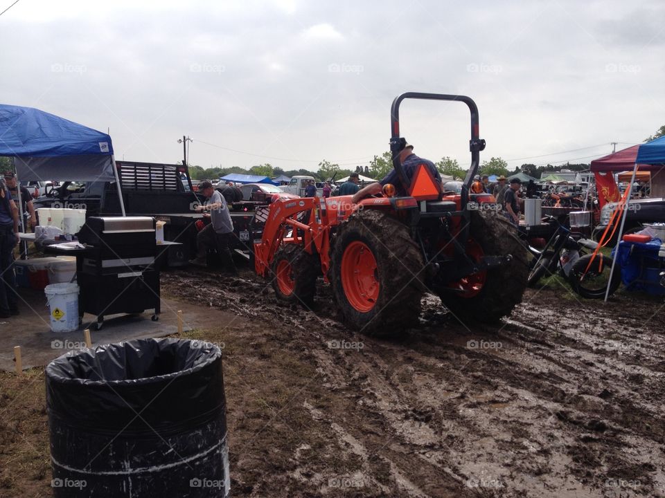 Swap meet. Tractor at muddy swap meet