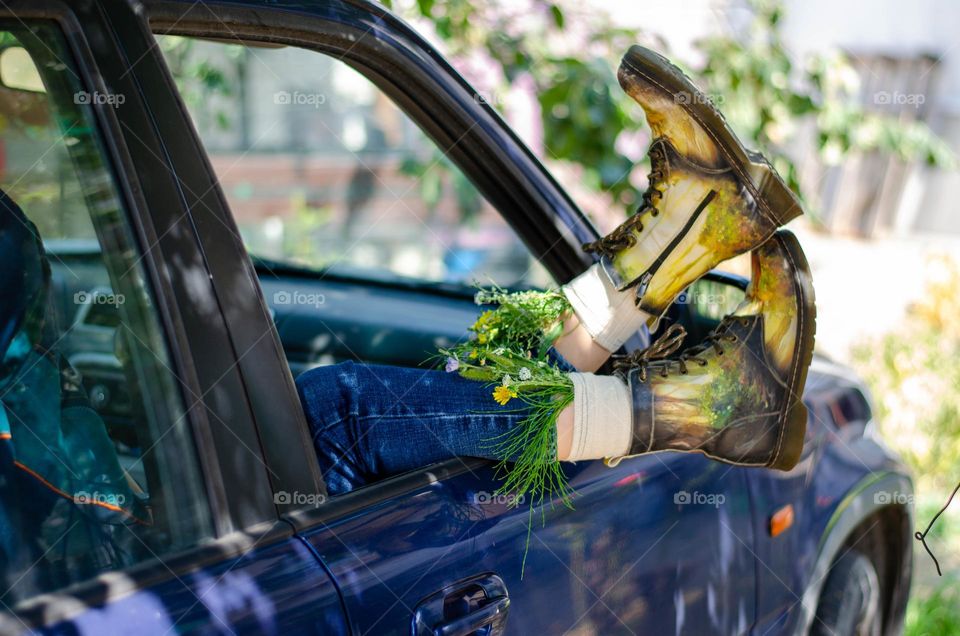 What's that doing here 😃? Woman Lying in Car With her Feet Out of Car Window. She Have Flowers Inside the Boots