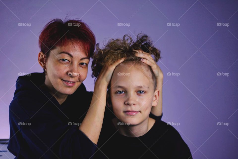 mother and son fool around in front of the camera and hug