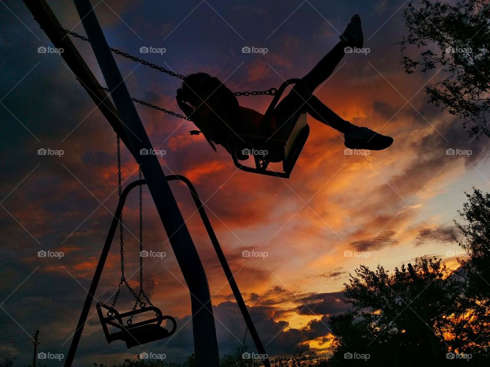 Girl on the swing. Summer evening mood