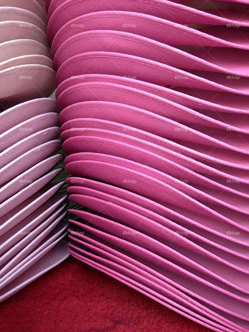 Lovely pink hats stacked together with repetition.