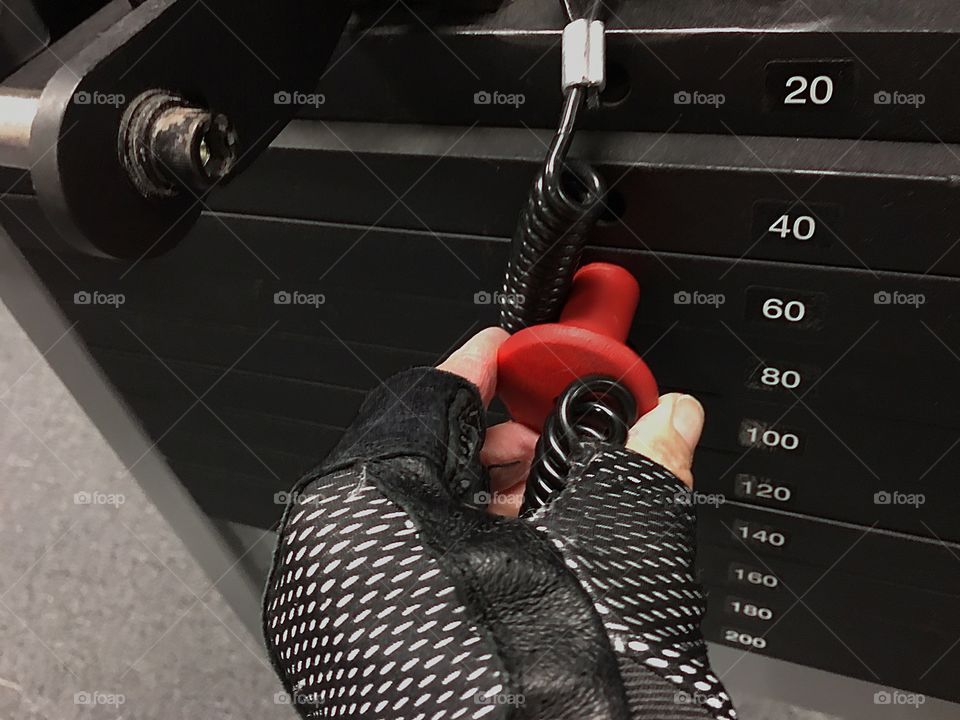 Lifting weights on a workout machine for health and fitness.