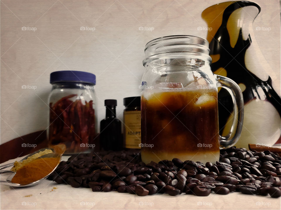 Iced cold brew coffee with spices and adaptogens in the form of medicinal mushrooms. Adaptogens are natural ingredients that help the body adapt to stress as per clinical studies.