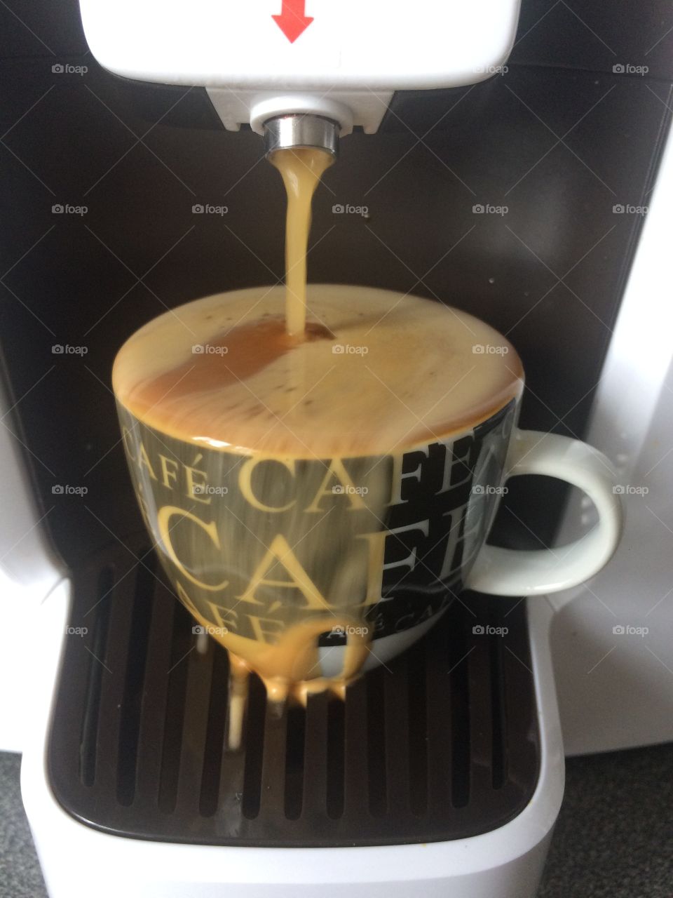 Overflowing espresso coffee cup