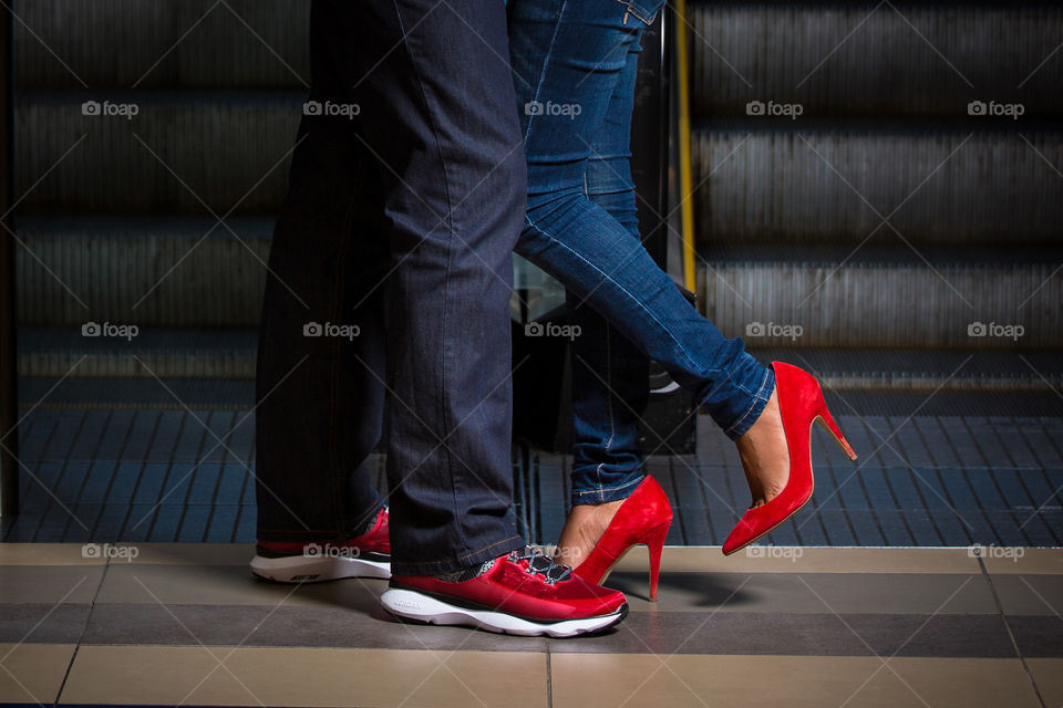 Blue! Image of couple together showing blue jeans and red shoes