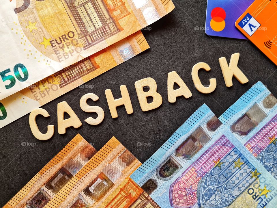background with cashback writing and banknotes and credit cards