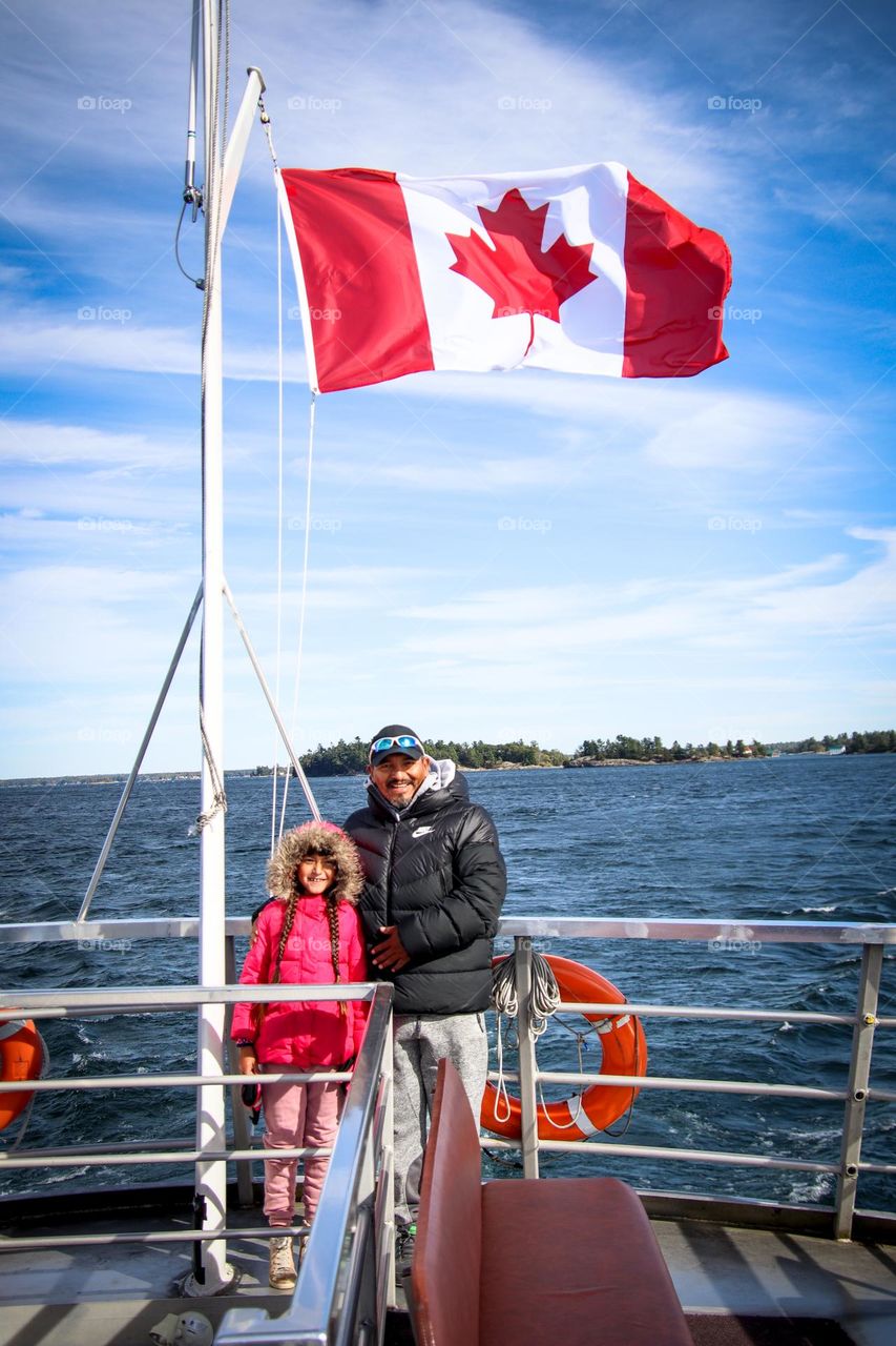 Father and daughter taking a boat ride during the Canada day