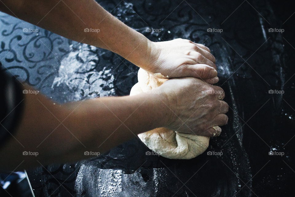 View of a person kneading flour