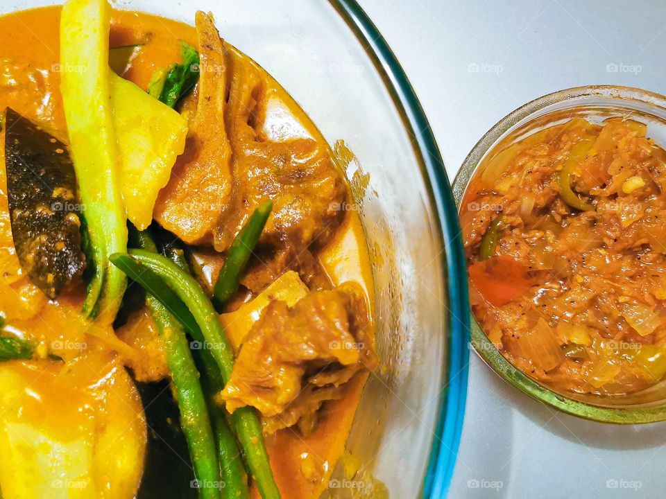Oxtail peanut butter stew or Kare Kare with sauteed shrimp paste. A Filipino dish.