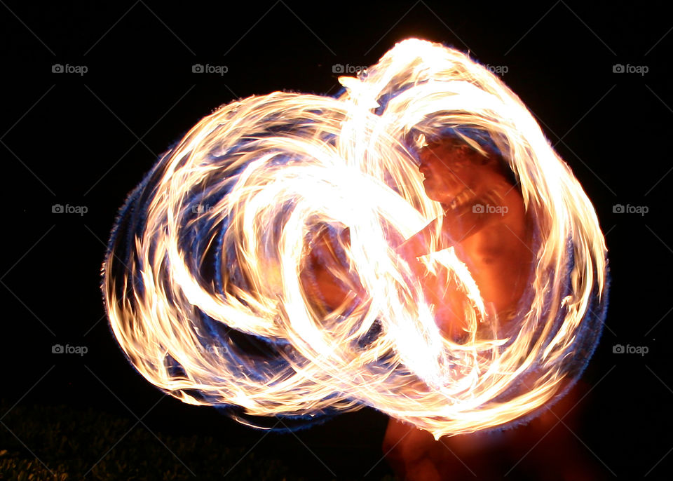 Man performing with fire flame at night