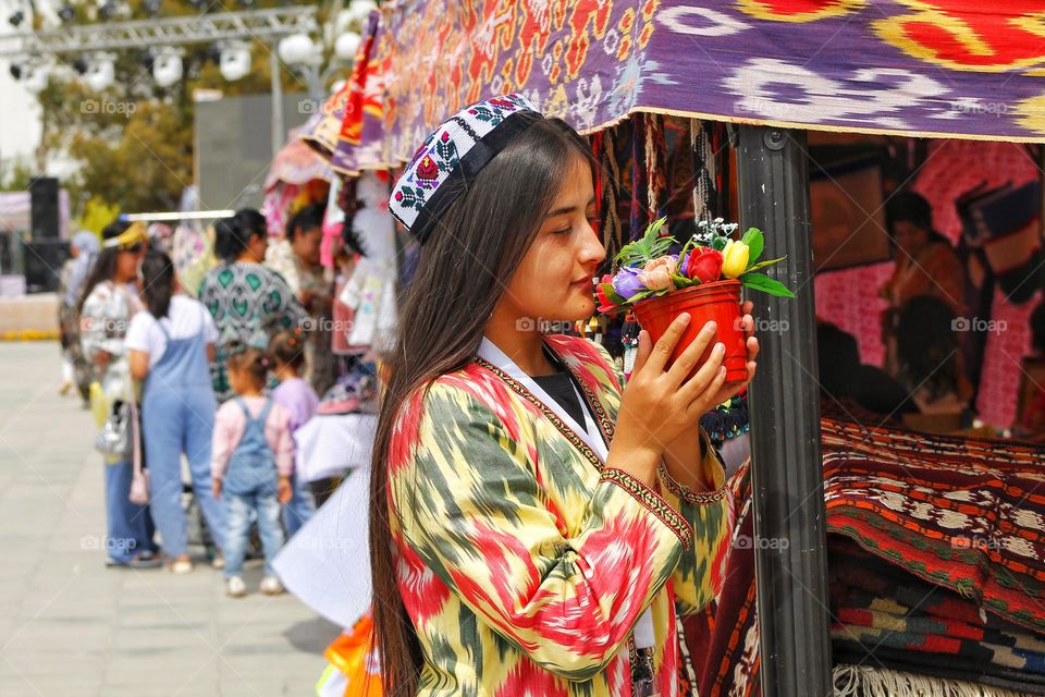 independence day in Uzbekistan. On the day of the holiday, people honor traditions by dressing up in national costumes and organizing fairs with performances.  in the photo of a girl in national festive  dresses.