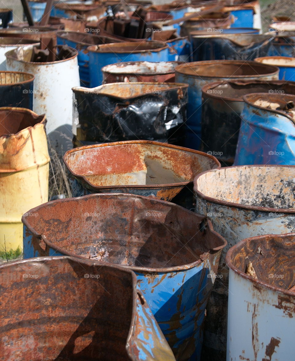 Rows of old and rusting oil drums. 
