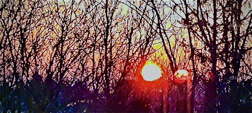 Through an extraordinary play of the light this fiery early morning sunrise appears mirrored In the sky over „Bavaria“, Germany. 2023. Hypnotic Productions