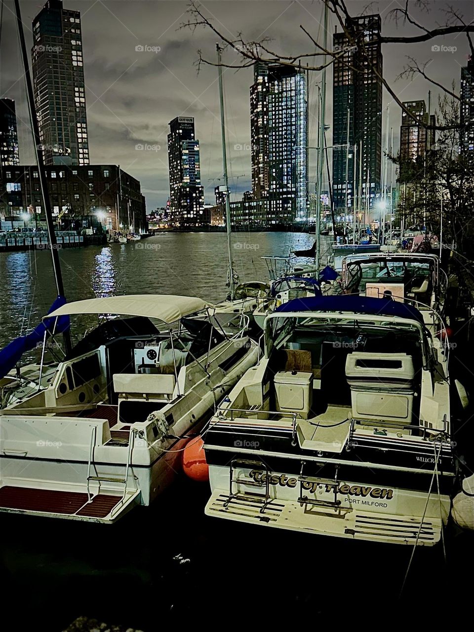 At night the boats at “Newtown Creek” in LIC, Queens look more amazing than ever. The waters of the “East River” are illuminated by the lights of the city and show a silvery sheen and a hint of a rainbow refraction effect. 2023. Hypnotic Productions
