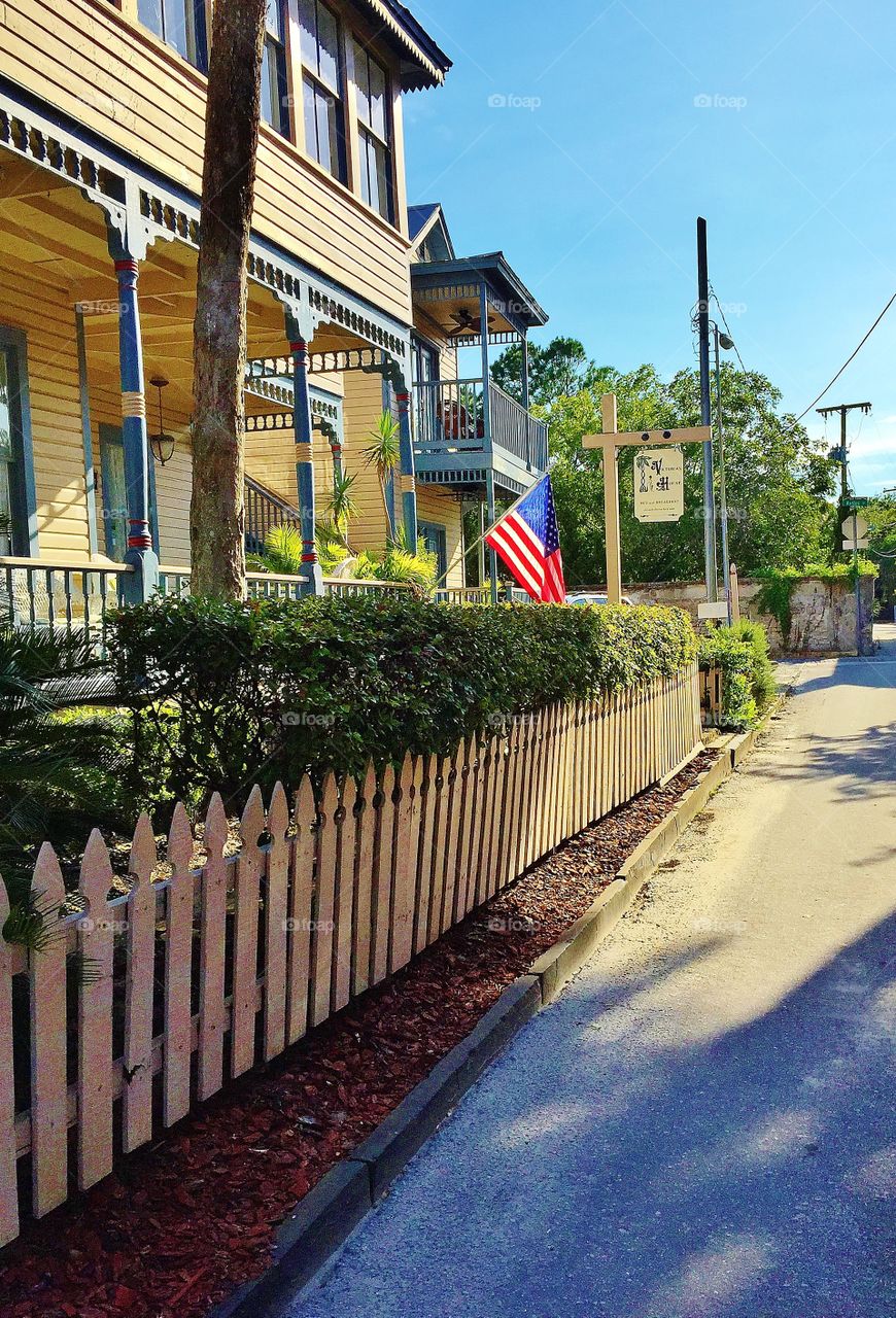  Street with houses and a flag. This is a residential street in St . Augustine Florida.