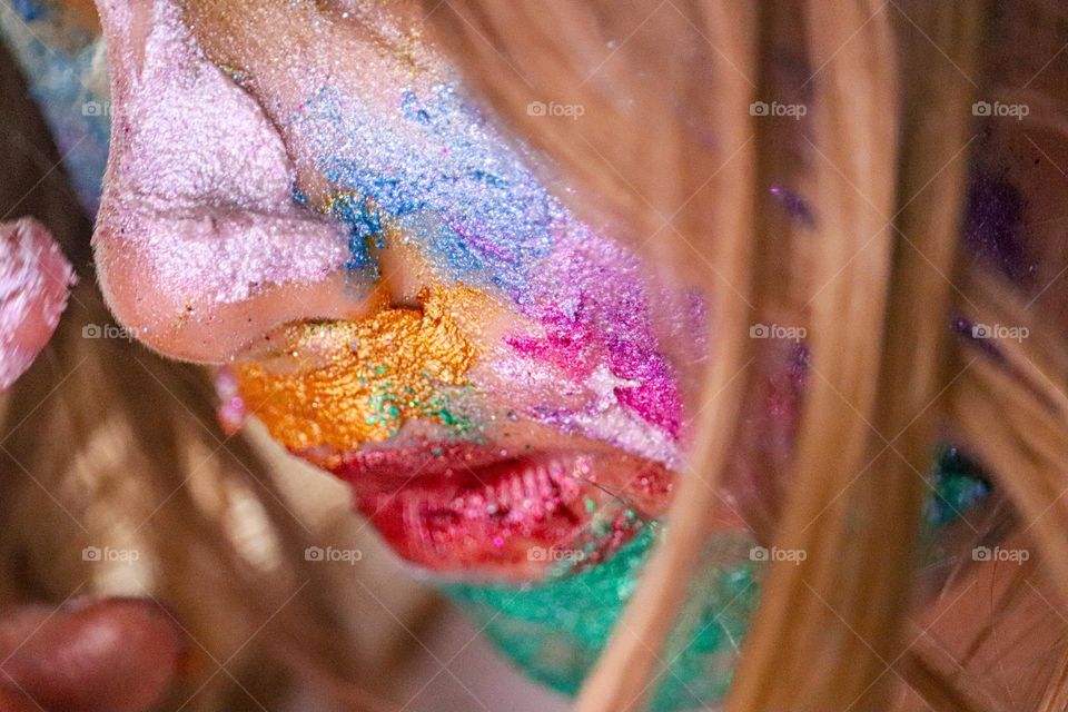 A child wearing glitter makeup