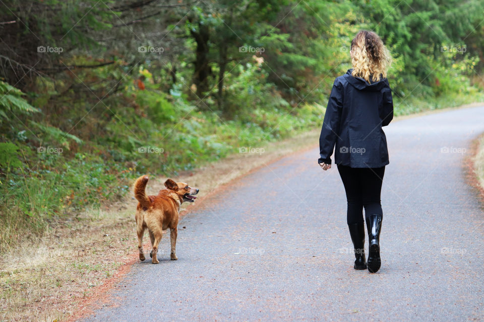 Young woman out for a walk with her dog