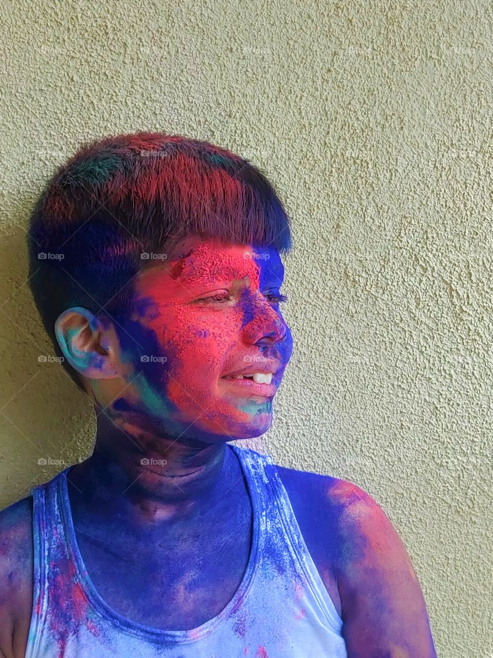 happy kid after  playing a fun filled colorful holi