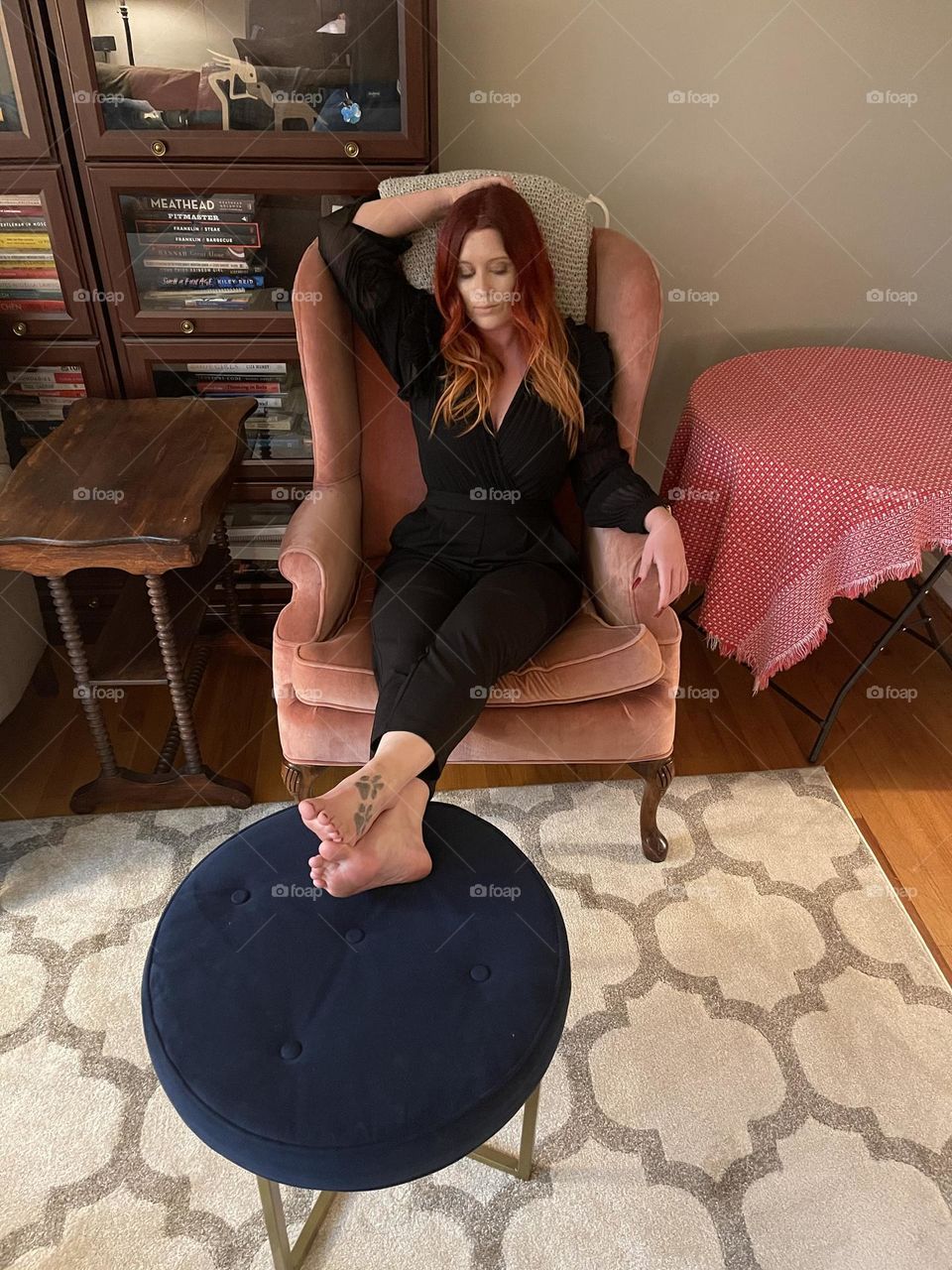 relaxing in the pink chair, feet on the stool, relaxing after a long day of travel! 