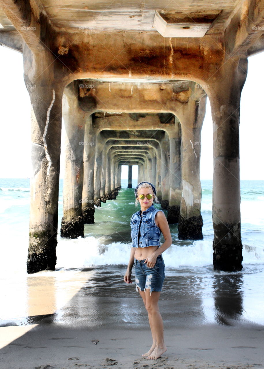 Woman standing under the bridge