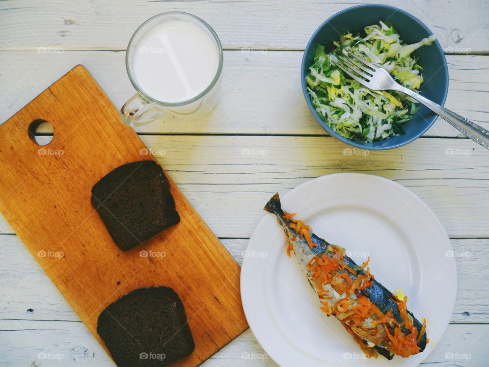 baked mackerel, vegetable salad and a cup of milk, breakfast