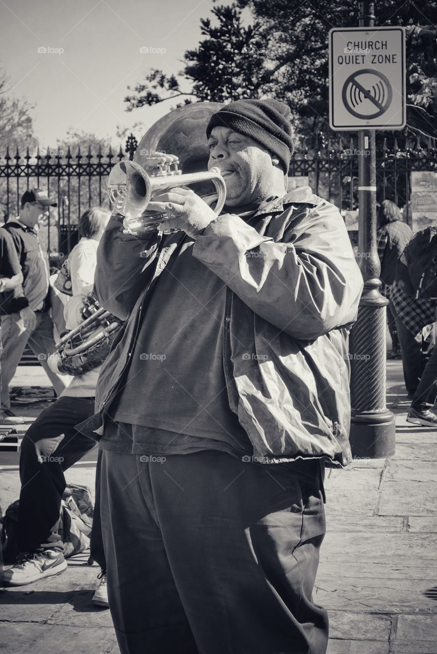 Following the tradition of New Orleans - a wonderful trumpeter on Jackson Square in the French Quarter, New Orleans, Louisiana, USA. This gentleman plays strongly and beautifully even in a church zone.