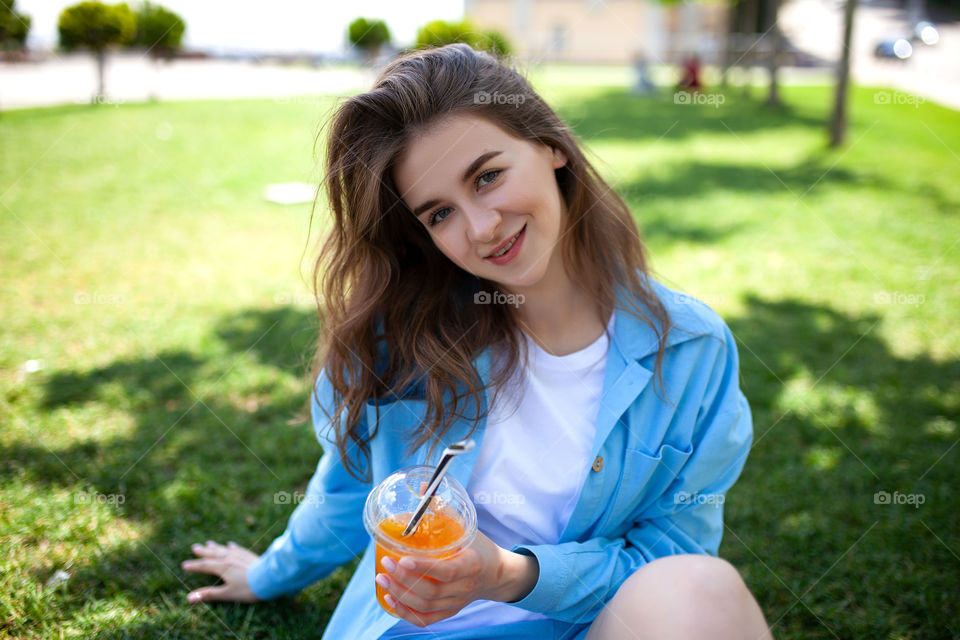 portrait photo of a woman with a cocktail in her hands