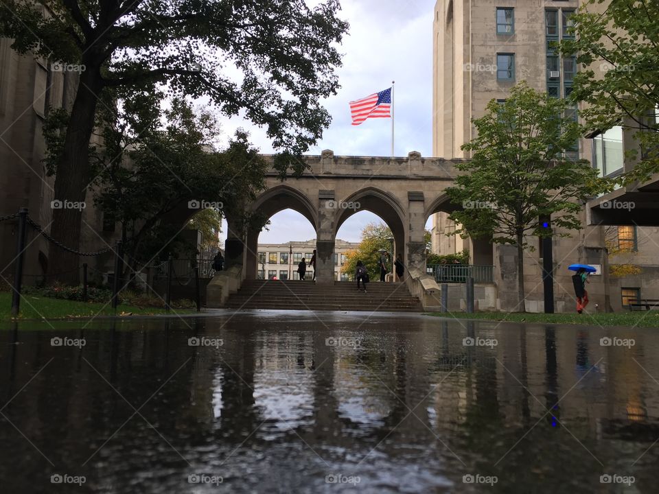 Arches reflecting on a rainy walkway 
